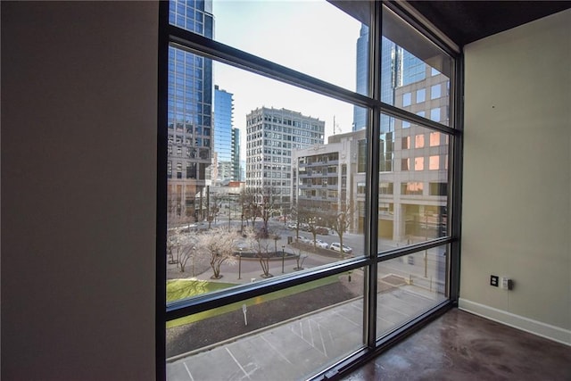 details featuring a view of city, finished concrete floors, and baseboards