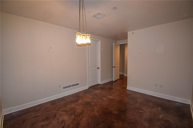 unfurnished room featuring visible vents, concrete floors, and baseboards