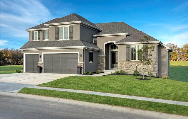 view of front of home featuring driveway, stone siding, an attached garage, a front lawn, and stucco siding