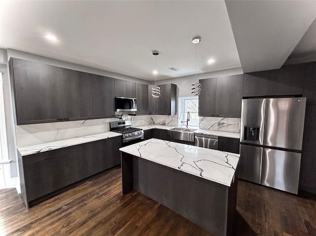 kitchen with appliances with stainless steel finishes, modern cabinets, dark wood finished floors, and a center island