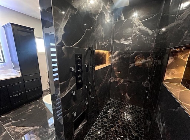 bathroom featuring a tub to relax in, marble finish floor, vanity, and a walk in shower