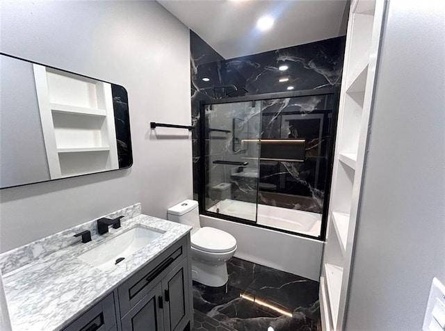 full bathroom featuring toilet, marble finish floor, combined bath / shower with glass door, and vanity