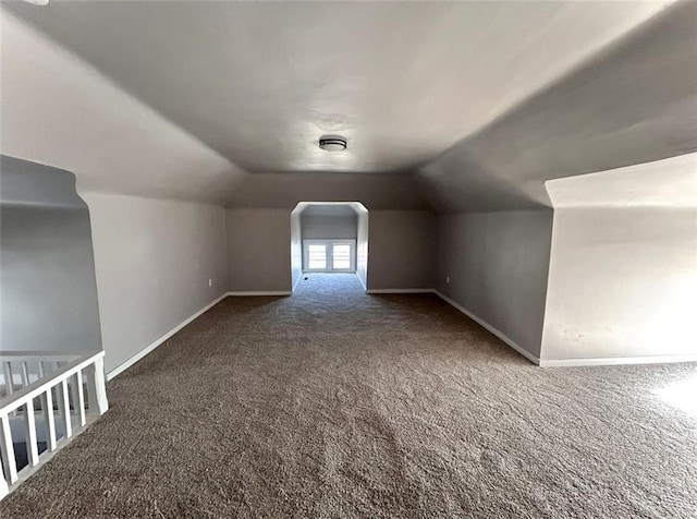 bonus room with carpet floors, baseboards, and lofted ceiling