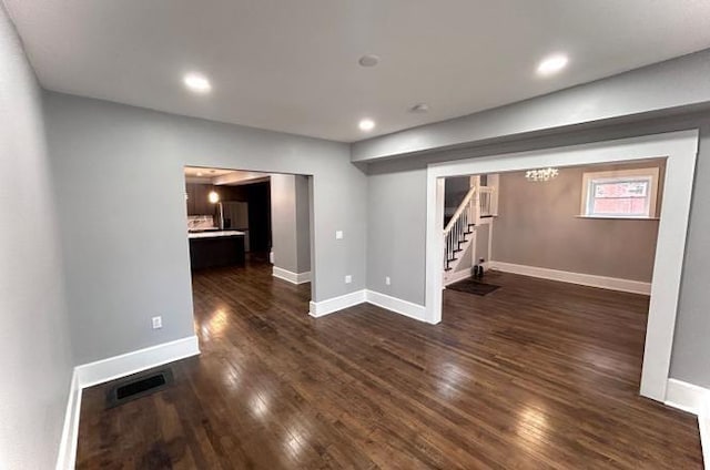 basement featuring baseboards, visible vents, dark wood finished floors, stairs, and recessed lighting