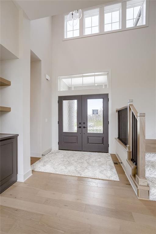 12455 N Arbor Way, Platte City, MO 64079 - entrance foyer with a high ceiling, light wood-style flooring, and french doors