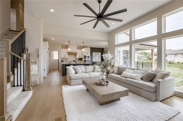 12455 N Arbor Way, Platte City, MO 64079 - living area with a ceiling fan, stairs, light wood-style floors, recessed lighting, and a high ceiling