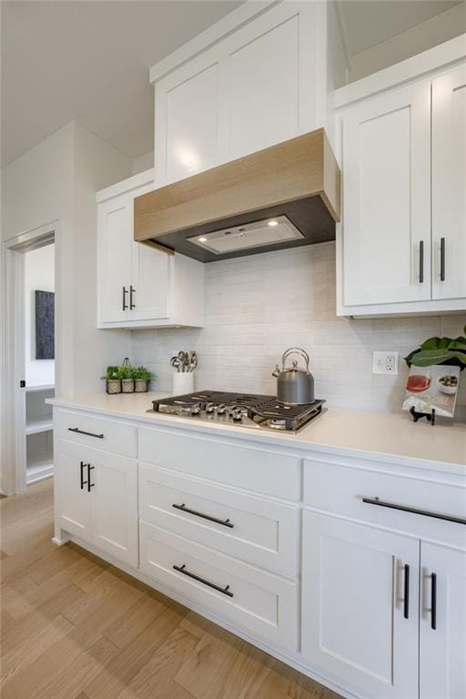 12455 N Arbor Way, Platte City, MO 64079 - kitchen with tasteful backsplash, light countertops, white cabinets, and light wood finished floors