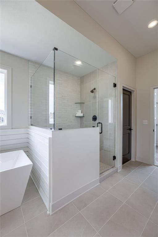 12455 N Arbor Way, Platte City, MO 64079 - bathroom with tile patterned floors, a stall shower, healthy amount of natural light, a freestanding tub, and recessed lighting