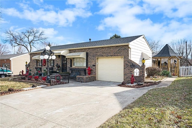 view of front of property featuring an attached garage, brick siding, a shingled roof, fence, and concrete driveway