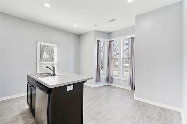 kitchen with a sink, visible vents, baseboards, light countertops, and dishwasher