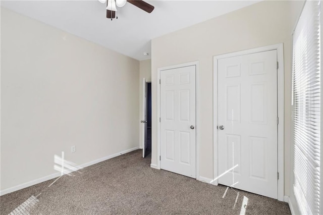 unfurnished bedroom with carpet, baseboards, and a ceiling fan