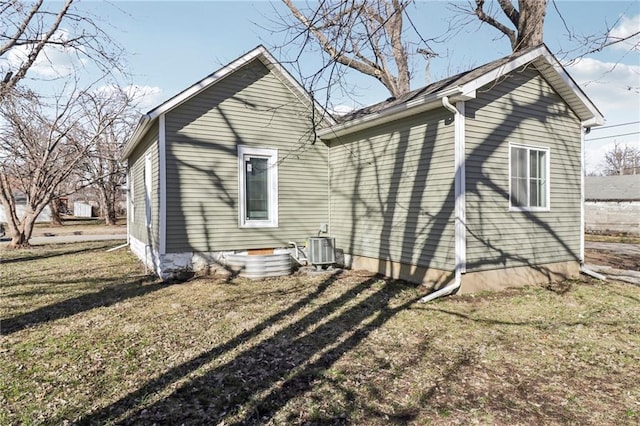 back of property featuring crawl space, central AC unit, and a yard