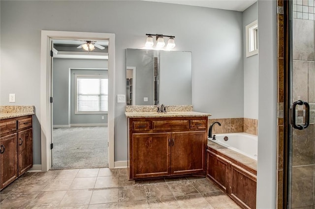 bathroom with a shower stall, baseboards, a bath, vanity, and a ceiling fan