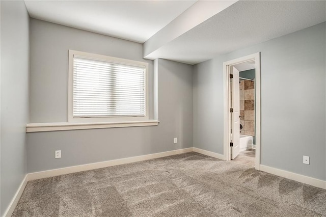 carpeted spare room with baseboards