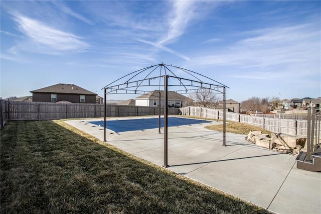 view of swimming pool featuring a yard, a patio, a fenced in pool, and a fenced backyard