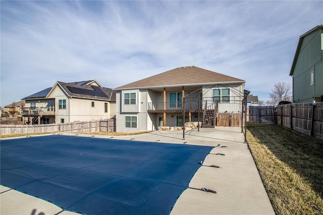 view of swimming pool featuring a patio, a gate, a fenced in pool, a fenced backyard, and a residential view