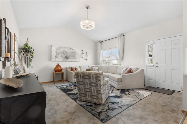 living room featuring carpet, lofted ceiling, and baseboards