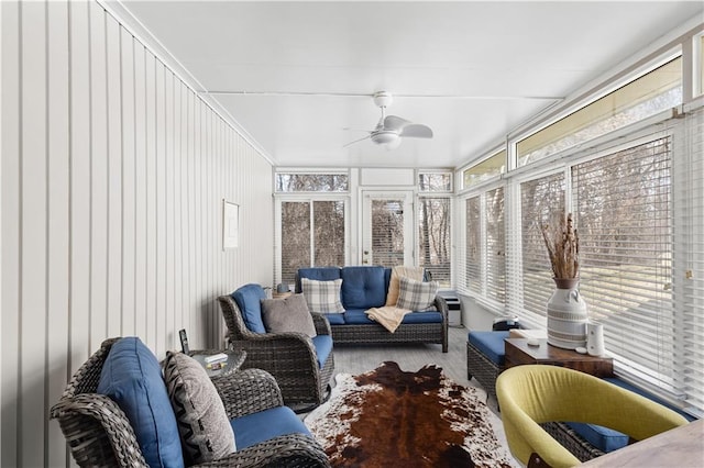 sunroom featuring a ceiling fan