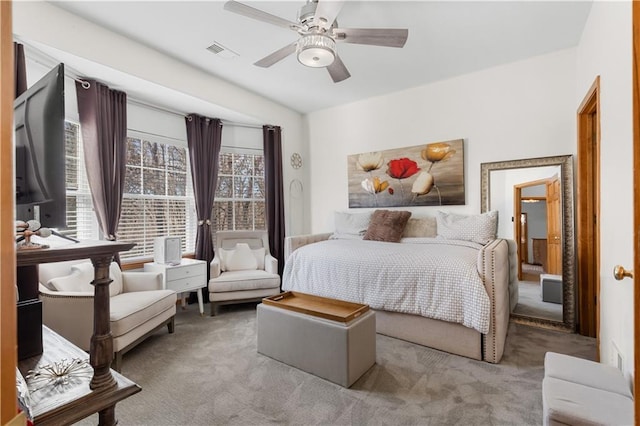 carpeted bedroom with a ceiling fan, visible vents, and multiple windows