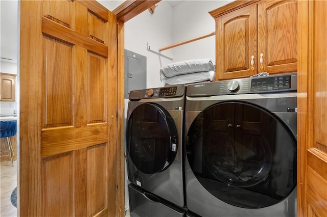 clothes washing area with cabinet space and washing machine and clothes dryer