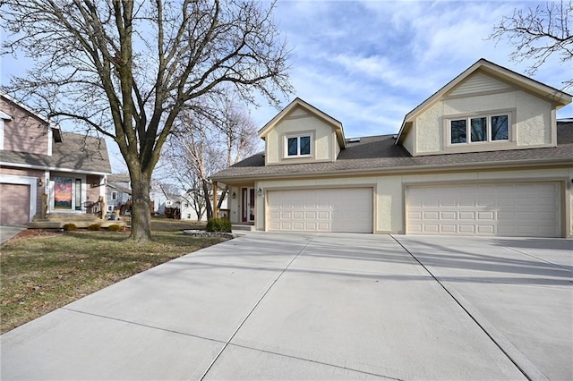 view of front of house featuring driveway, an attached garage, and stucco siding