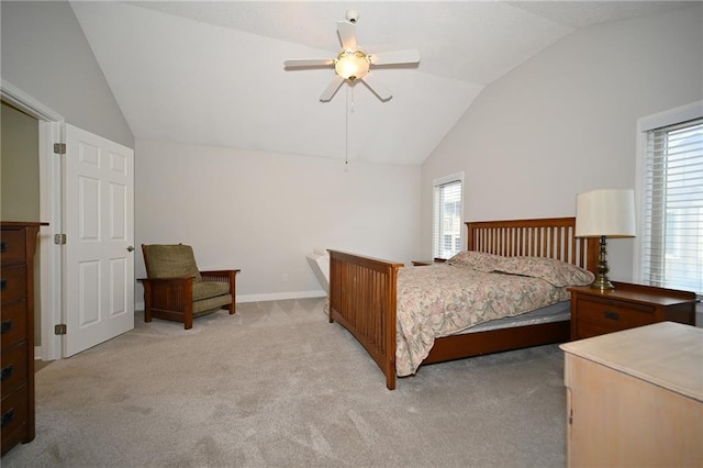 bedroom with light colored carpet, vaulted ceiling, baseboards, and ceiling fan