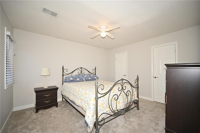 bedroom with carpet floors, visible vents, ceiling fan, a textured ceiling, and baseboards