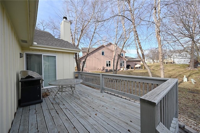 deck with area for grilling and a residential view