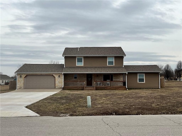 traditional home with driveway, a porch, an attached garage, and a shingled roof