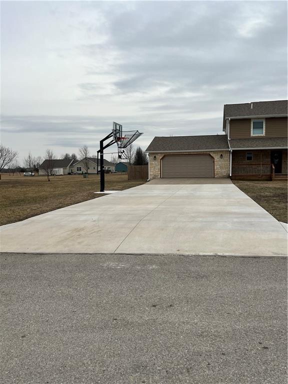 exterior space featuring a front lawn, driveway, and an attached garage