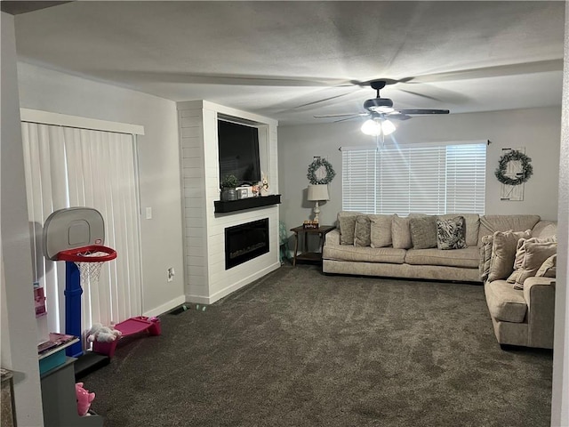 living area with carpet floors, a large fireplace, baseboards, and a ceiling fan