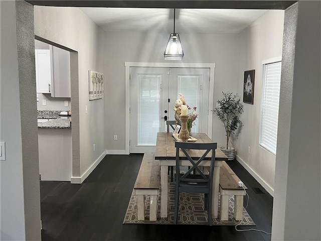 dining room with baseboards, dark wood finished floors, and french doors