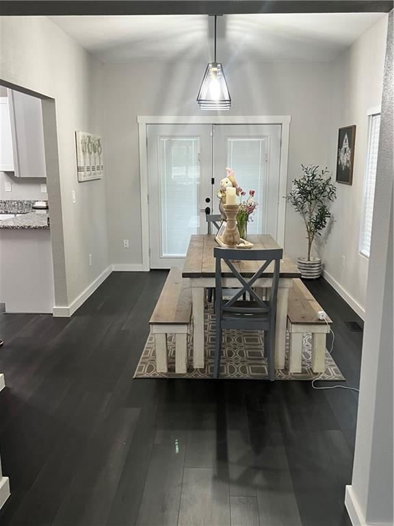 dining area with dark wood finished floors and baseboards