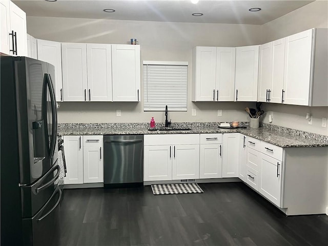 kitchen with dark wood-style floors, a sink, fridge with ice dispenser, light stone countertops, and dishwasher