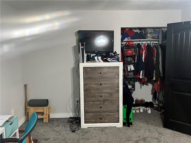 carpeted bedroom with a closet and baseboards