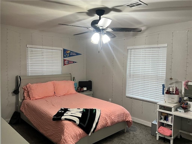 bedroom with carpet, visible vents, and ceiling fan