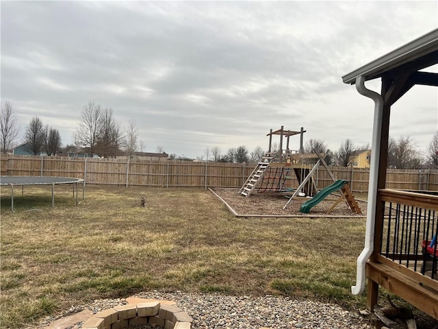 view of play area with a yard, a trampoline, and a fenced backyard