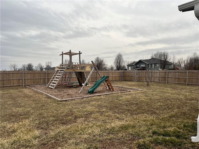 view of jungle gym with a fenced backyard and a lawn