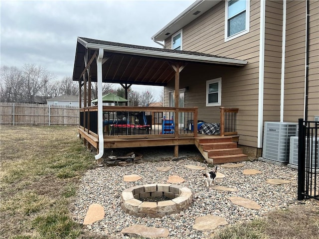 exterior space featuring fence, a fire pit, and central AC unit