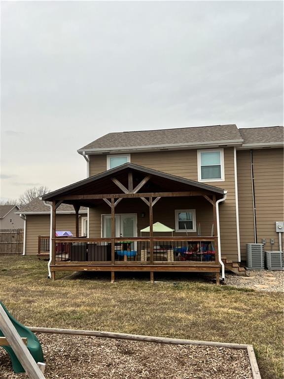 back of property featuring a deck and central AC unit