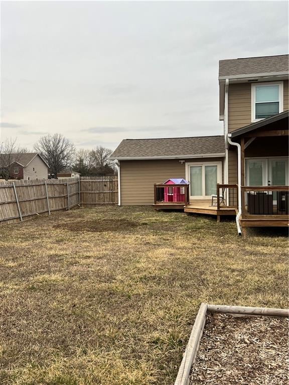 view of yard featuring a fenced backyard and a wooden deck