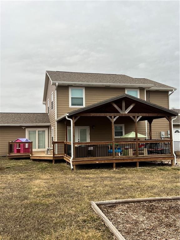 view of front facade with a front yard and a deck