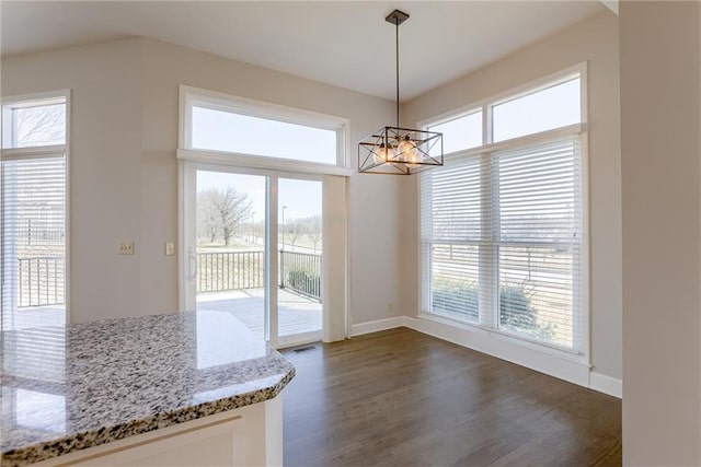 unfurnished dining area featuring visible vents, baseboards, dark wood-type flooring, and a notable chandelier