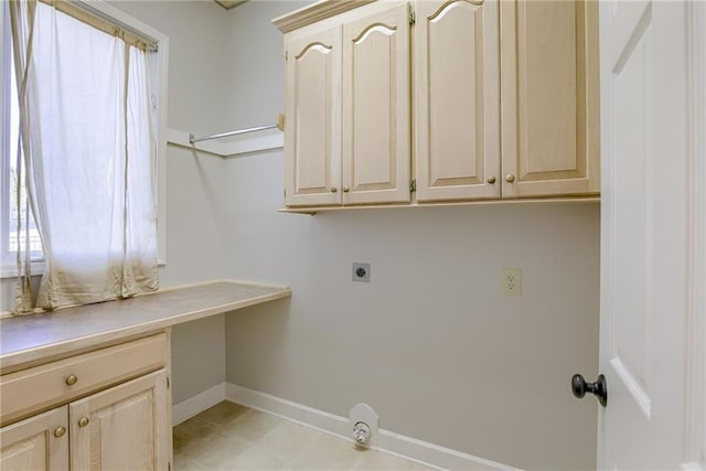 laundry room featuring cabinet space, baseboards, and hookup for an electric dryer