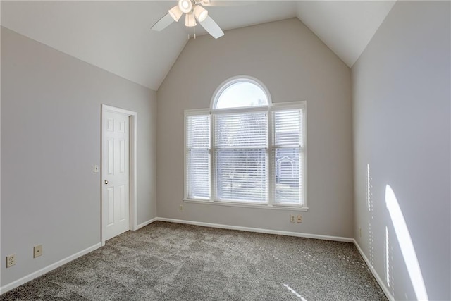 carpeted spare room featuring baseboards, lofted ceiling, a healthy amount of sunlight, and a ceiling fan