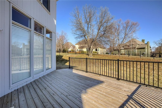 wooden terrace featuring a residential view and a fenced backyard