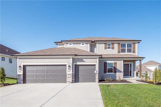 prairie-style home featuring a garage, a front lawn, concrete driveway, and stucco siding