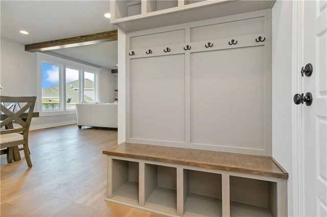 mudroom with beamed ceiling, light wood-type flooring, and recessed lighting