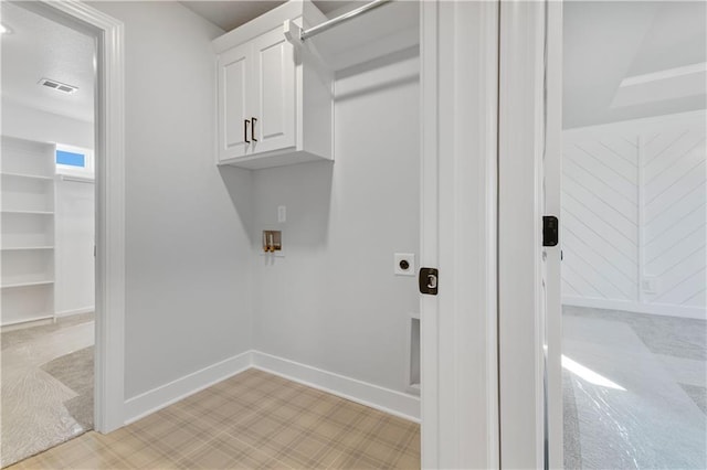 laundry room featuring washer hookup, cabinet space, visible vents, hookup for an electric dryer, and baseboards