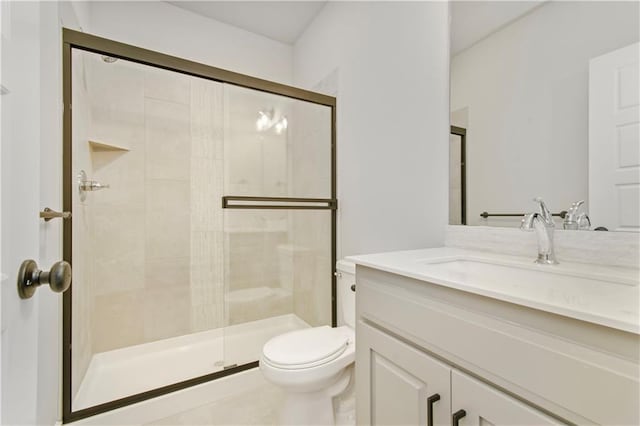 full bathroom with a stall shower, vanity, and toilet